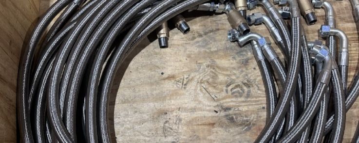 Finished braided hose assemblies laid out for inspection