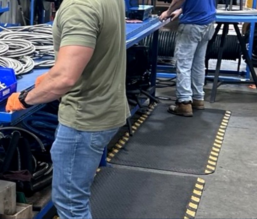 S&J technicians assembling braided hose lines on the shop floor in Griffin, Georgia